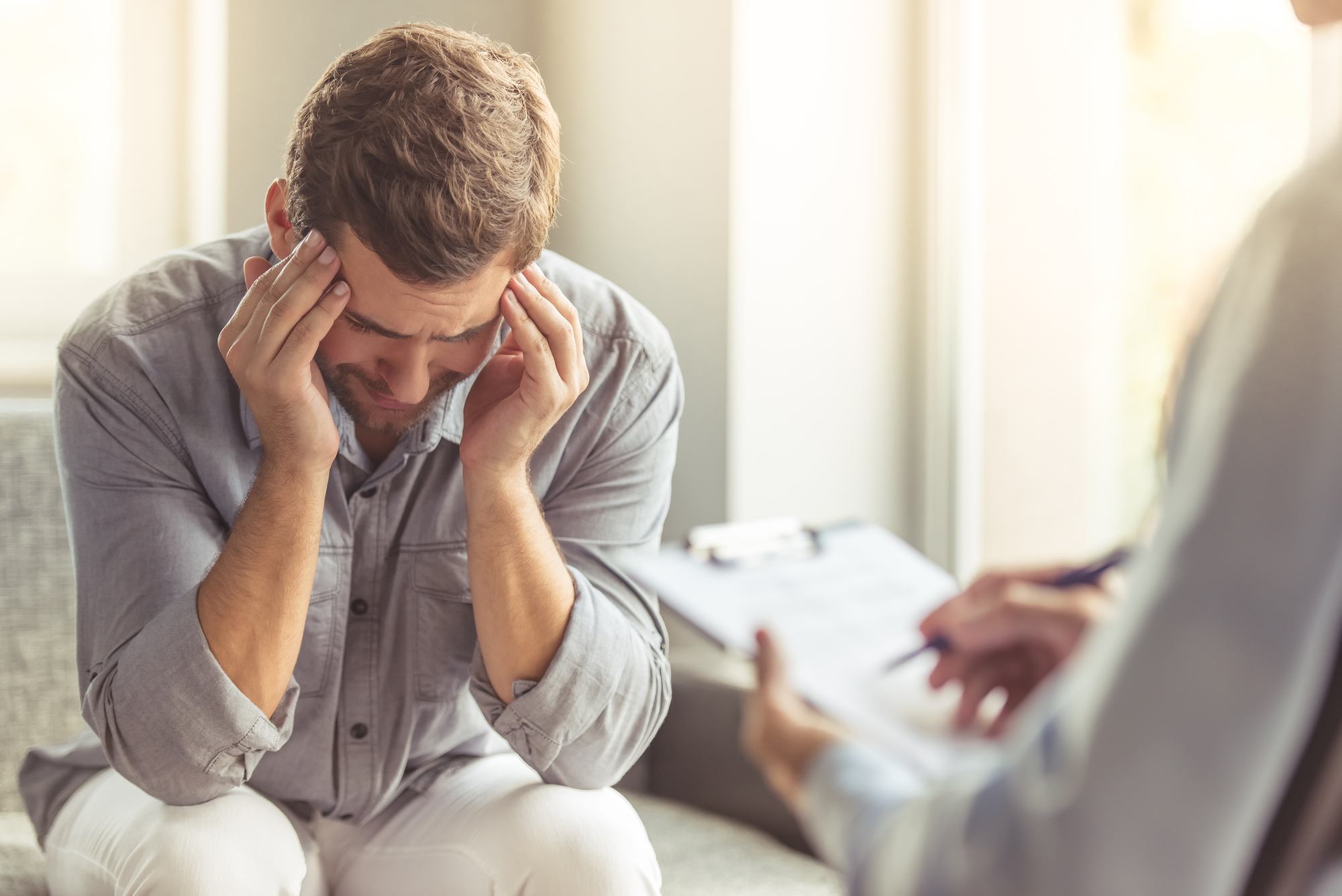 Depressed Man in Casual Clothes During a Therapy Session
